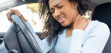 Woman in car with neck pain